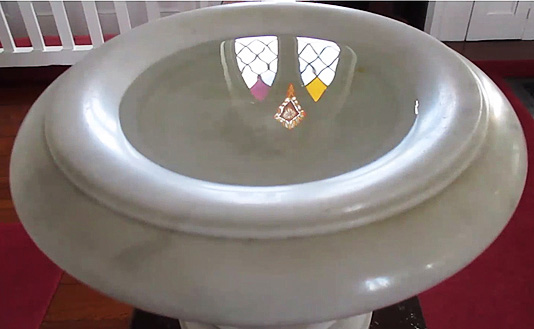 Baptism font in the middle of the altar